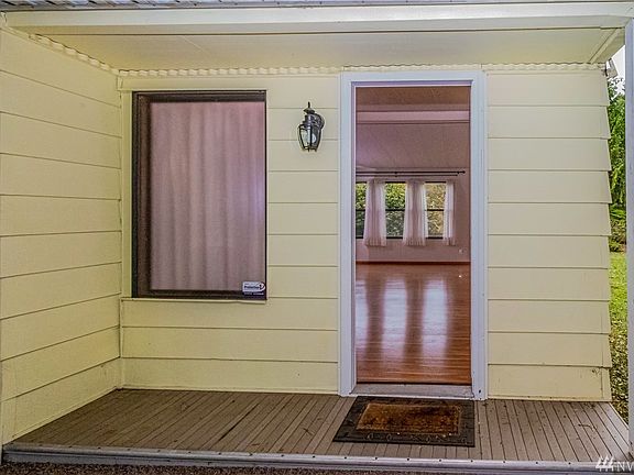 Entrance from the front door into the living room. Dining table is to the right and kitchen beyond that next to the next living room.