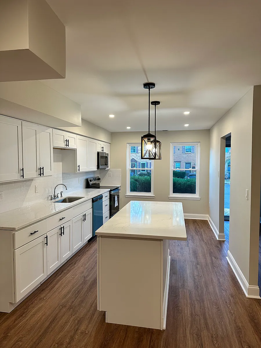Bright, modern kitchen with brand-new stainless steel appliances, a large center island, and oversized windows bringing in incredible natural light_creating an inviting space to cook, gather, and entertain. - 55 Providence Ave