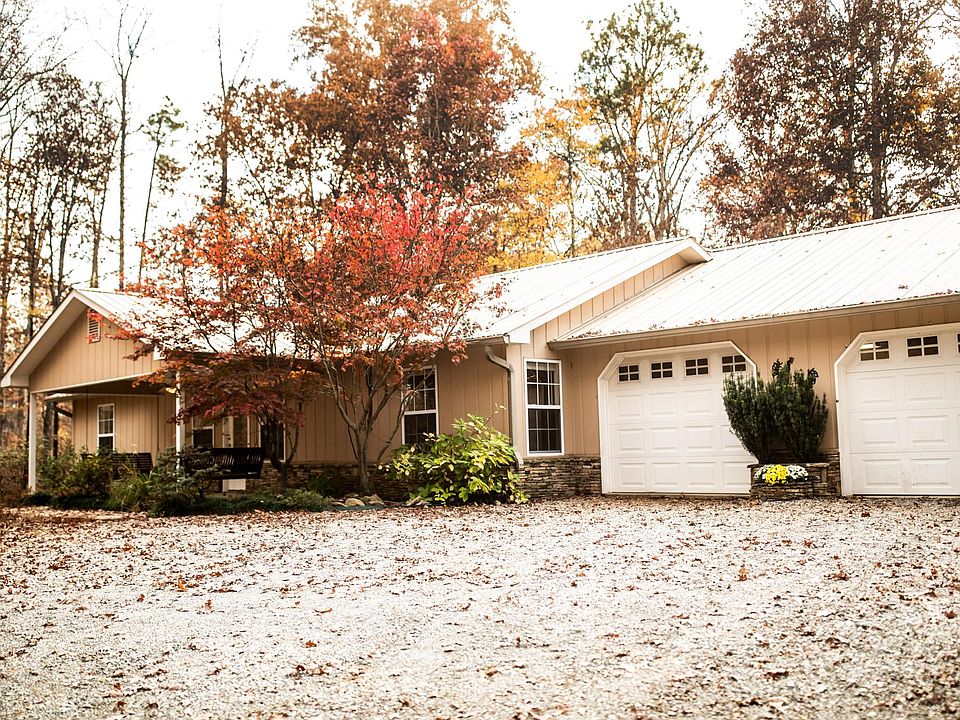 Beautiful home on a short gravel drive, surrounded by tall trees and gorgeous scenery.