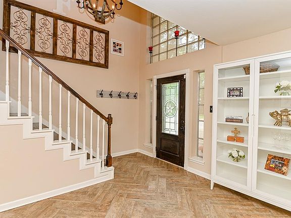 Notice the stylish chandelier that decorates the entry.