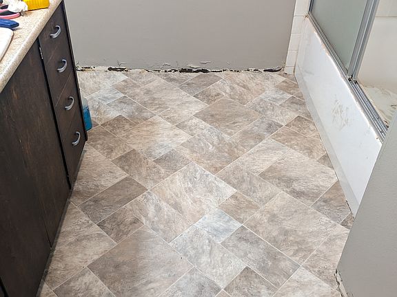 The bathroom is getting a new floor