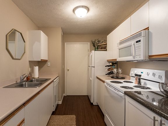 Our model Liberty kitchen features both upgraded cabinetry with dark countertops and classic cabinetry with light countertops.