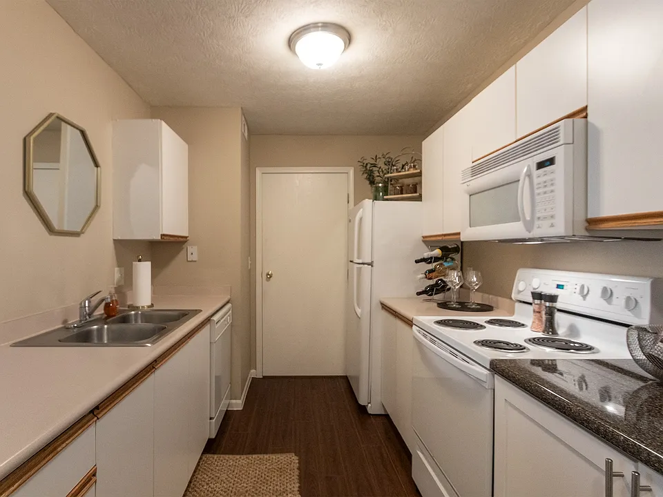 Our model Liberty kitchen features both upgraded cabinetry with dark countertops and classic cabinetry with light countertops.