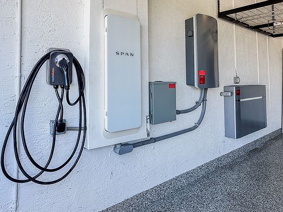 EV car charger and battery backup are installed in the garage.