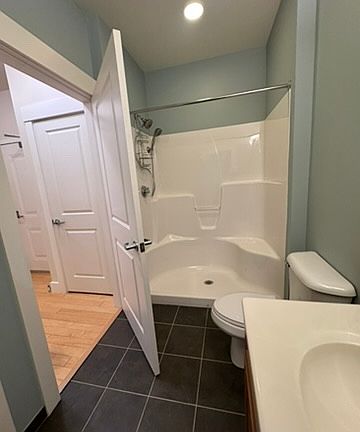 Second Bedroom bath off of the kitchen, with laundry.