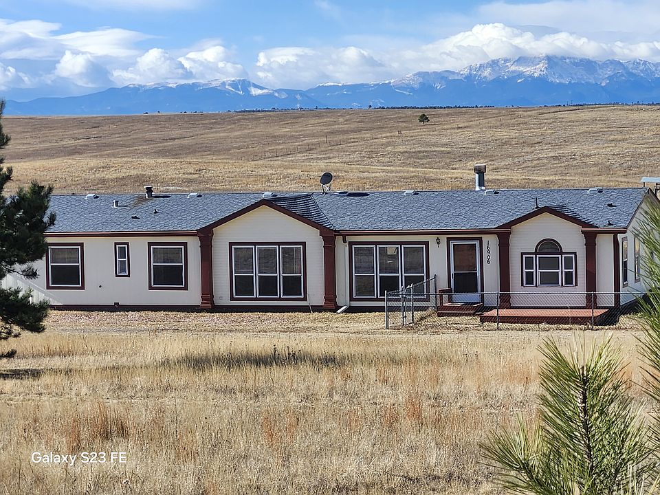 Front of home with snow covering Pikes Peak.