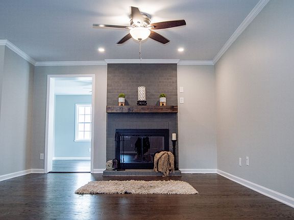 A remote-controlled brick gas log fireplace is the centerpiece of the great room