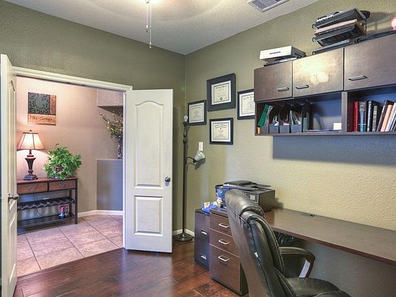 Recent laminate wood floors in study off of entry