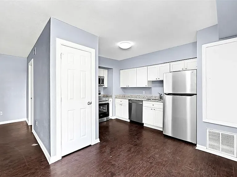 Open concept kitchen with stainless steel appliances.