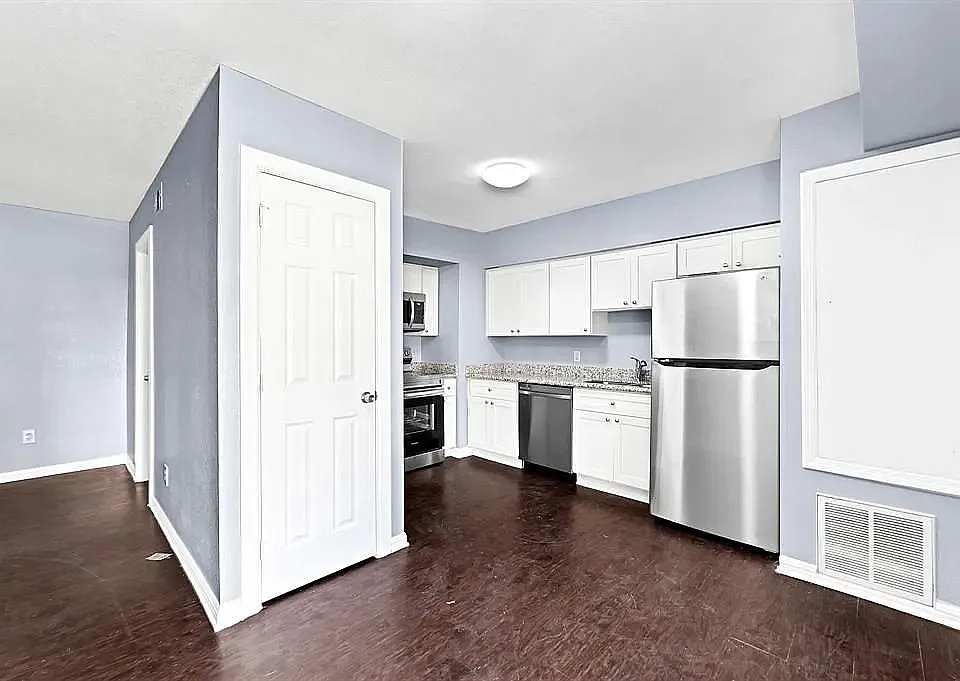 Open concept kitchen with stainless steel appliances.