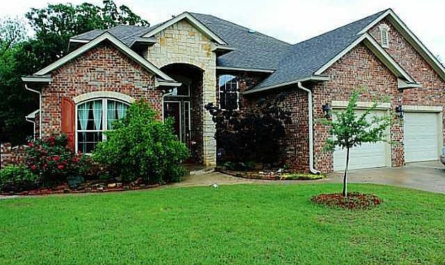 Exterior Front. Beautiful exterior with stunning landscaping, stone, arched entry and over sized tandem garage that allows for 2 cars and space for 3rd vehicle or workshop space