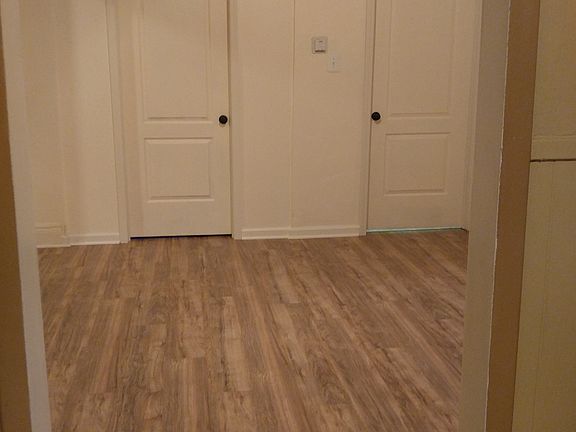 Master bedroom with brand new handscraped pecan flooring and
