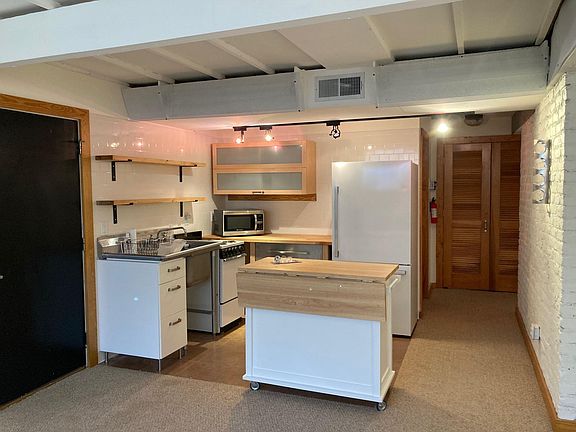 Kitchen. Washer/dryer in closet seen at end of hall.