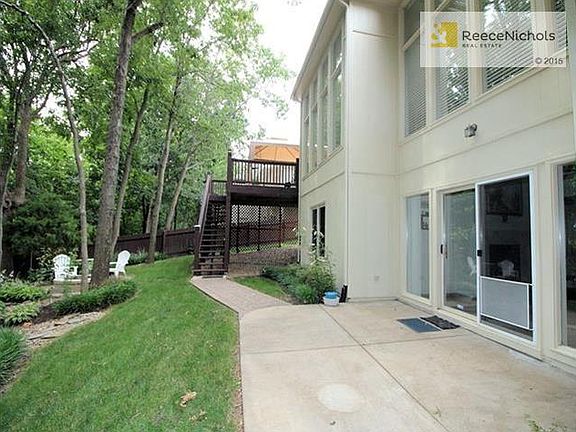 Walkout from the lower level family room, firepit surrounded by flagstone patio and deck comes off hearth room and kitchen area.