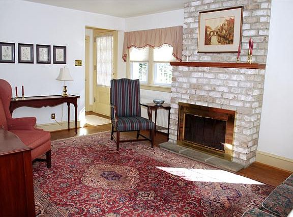 Brick hearth fireplace is the focal point.