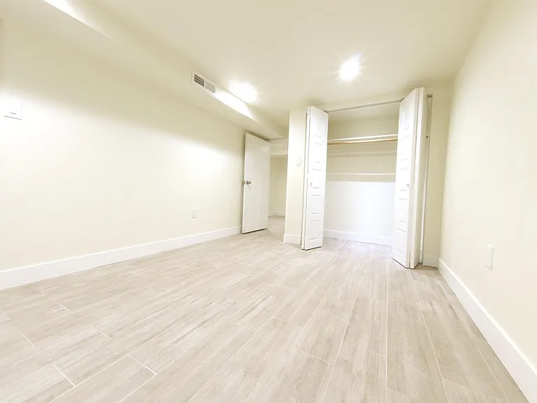 Bedroom # 5 with closet looking towards laundry room