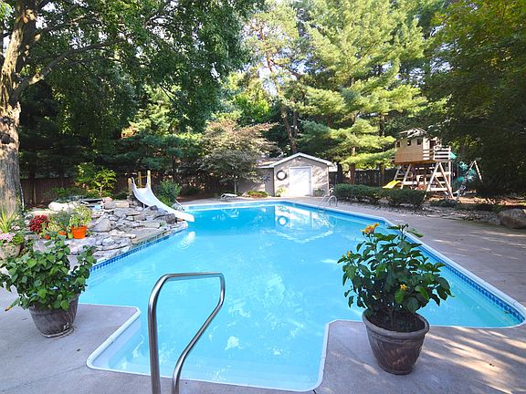 Look at this entry to your beautiful pool. Tons of storage for all your fun pool toys in the oversized shed that also has an adjoining changing room. Also, notice the large play scape for the kids