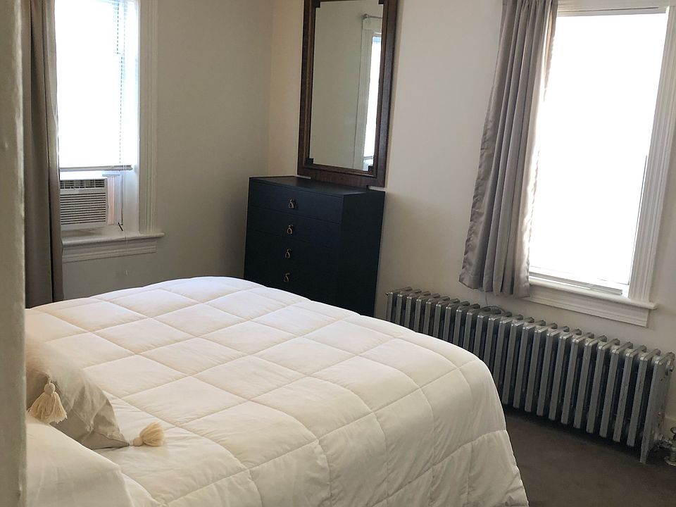 Sun filled bedroom with premium linens and ultra comfortable mattress.