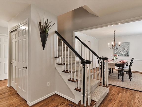 View of dining room from center hall foyer with newly painted spindles, refinished stairs with new carpet