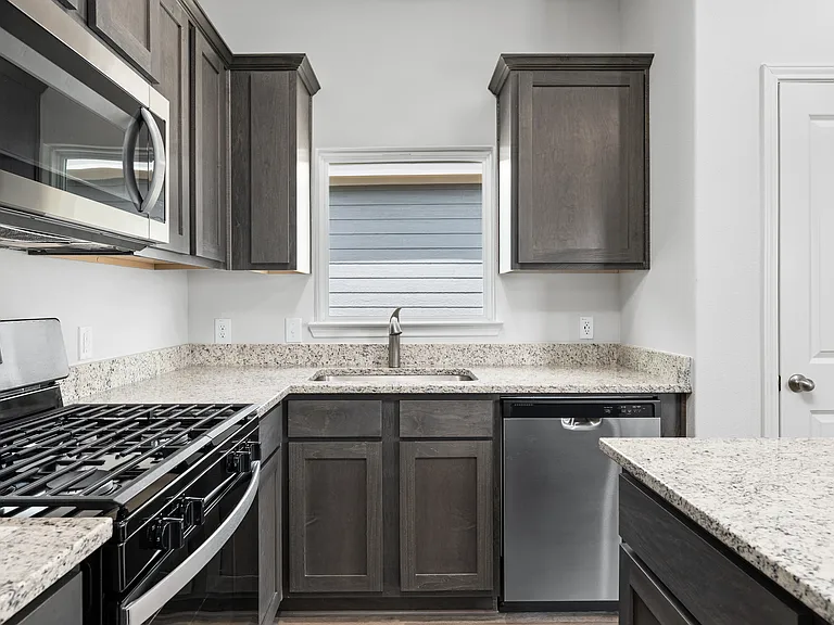 The kitchen has sprawling granite countertops.