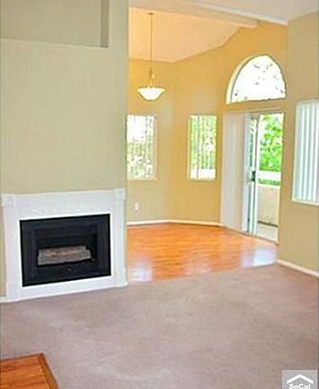 Living room with fireplace and vaulted ceilings