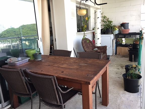 Recently painted 120 sf lanai adds living space and a place for plants and furniture