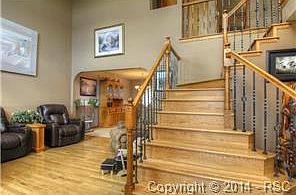 Elegance & Warmth Abound With Lots Of Hardwood & Wrought Iron Railings!