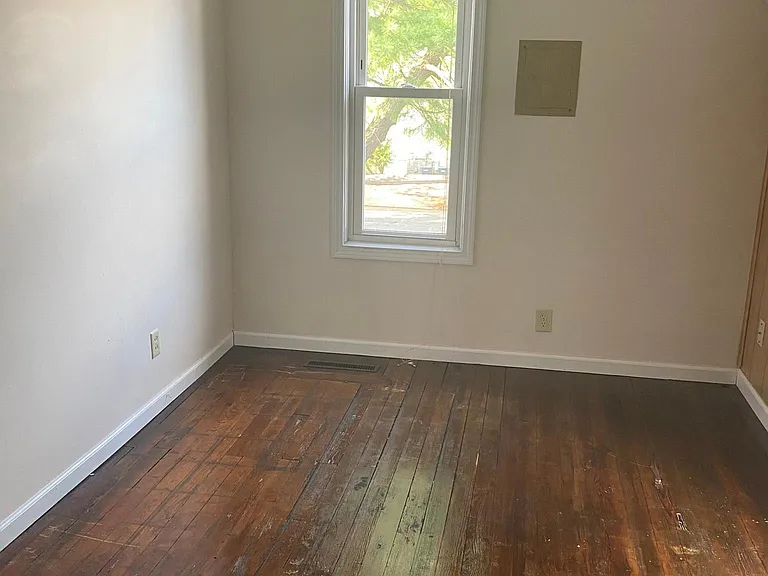 Back upstairs bedroom. hardwood floors. ceiling fan