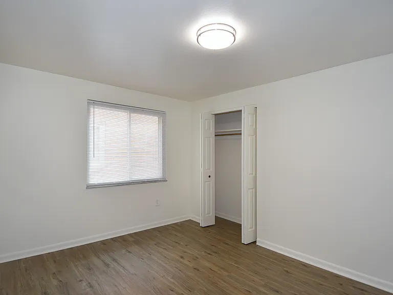 Freshly painted spacious bedroom #1 with all-new luxury vinyl plank flooring, new mini-blinds & LED lighting.