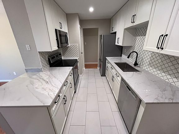 New kitchen with custom cabinetry and quartz countertops