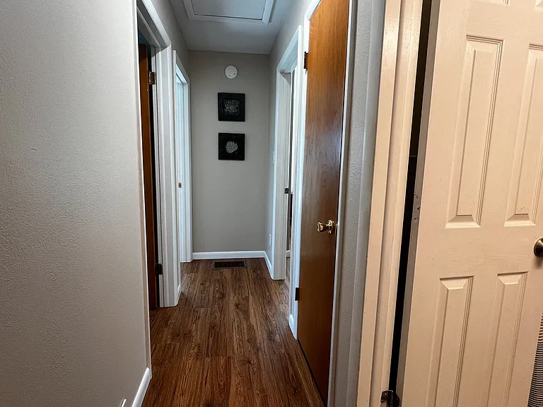 Hallway connecting three bedrooms to the upstairs full bathroom.