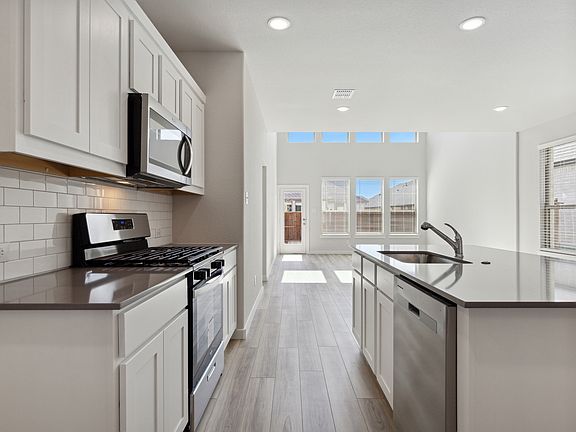 Kitchen in the Mesquite home plan by Trophy Signature Homes - REPRESENTATIVE PHOTO