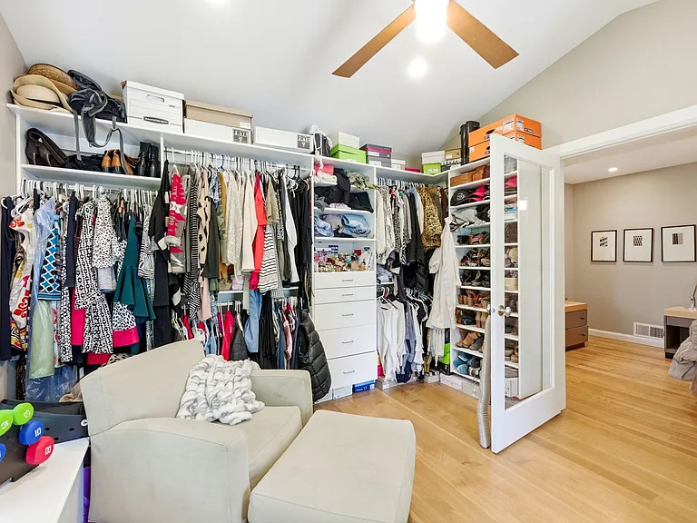 Master bedroom walk-in closet with huge windows facing the backyard.