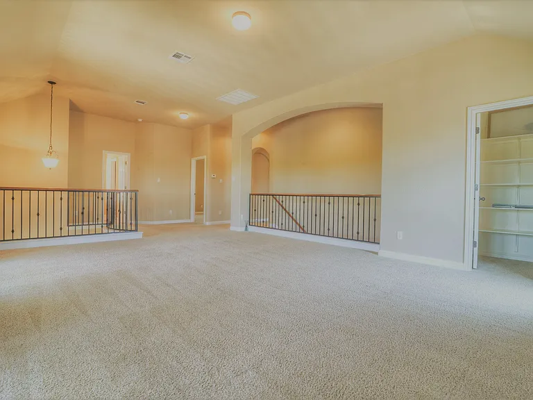 Upstairs living room area looking towards stairs and the bedrooms. Extra storage closet on the right. This room is great for toys/playroom, home gym, yoga/wellness space, media room.