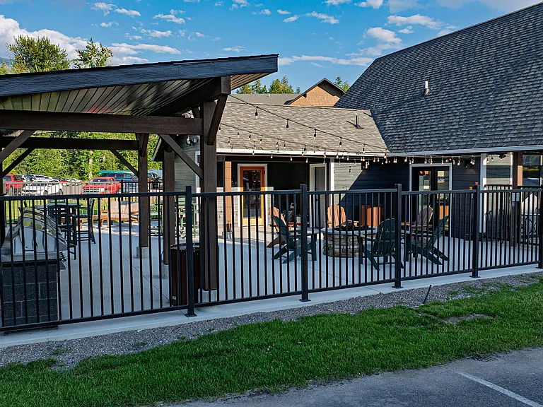 Patio area with BBQ grills, soft seating and a fire pit