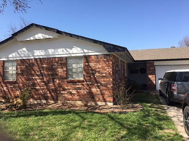 Covered entry and landscaping and shrubs added. 
