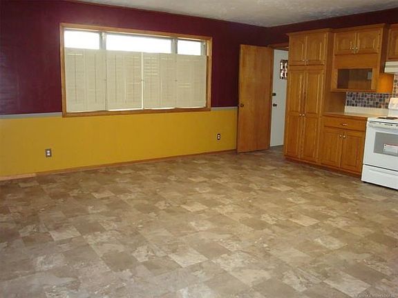 Large open kitchen looking towards entrance to laundry, 1/2 bath, back door & garage entrance.