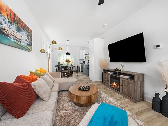 Living room with 65inch 4k smart TV and TV stand with fireplace