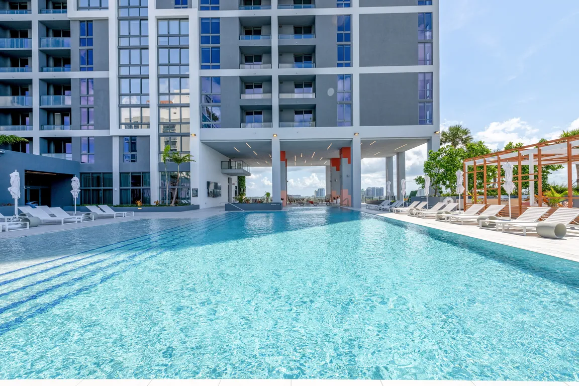 Indulge in the Miami sun on our expansive pool deck, offering luxury seating and a poolside bar