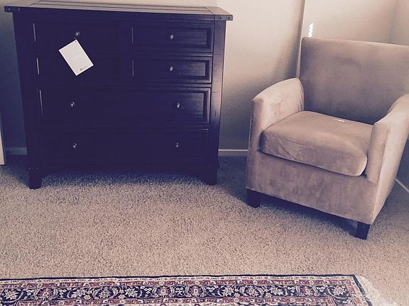 Master bedroom with dresser and chair