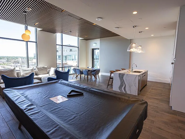 Lounge with pool table, tv and kitchen