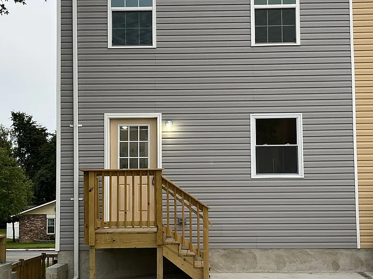 Back of home with driveway