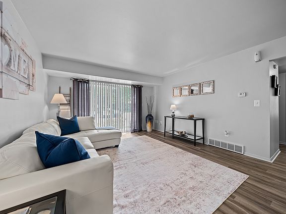 Spacious living room with natural light at Westwood Village Apartments in Westland, MI