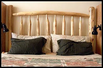 Owner-built Aspen wood latilla headboard on king size bed.