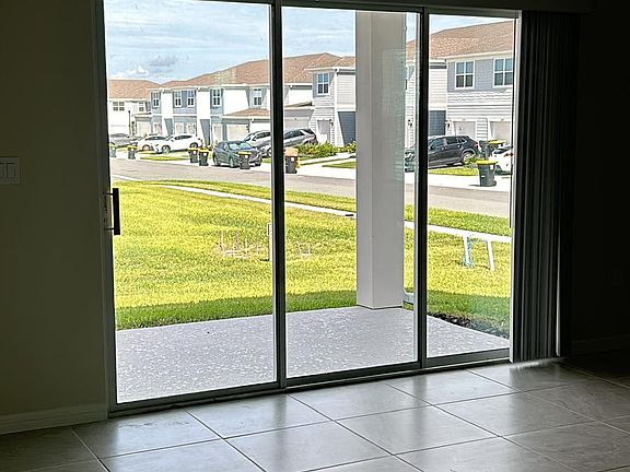 Three panels sliding door in the living room area.