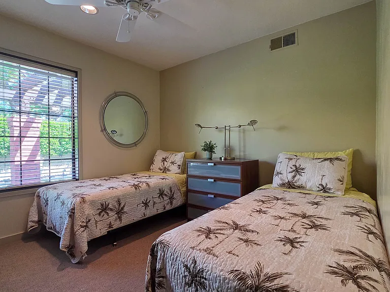 Third bedroom with 2 twin beds, dresser and wardrobe.