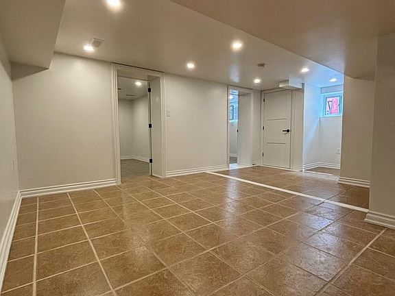 open-concept main room with kitchen/living/den/dining space