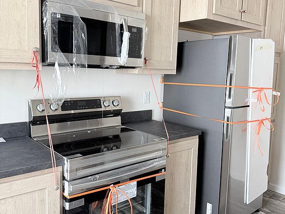 ELECTRIC STOVE, MICROWAVE HOOD, REFRIGERATOR, LOTS OF KITCHEN CABINETRY
