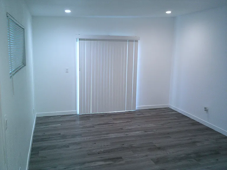 Bedroom 3, facing rear patio door 1.