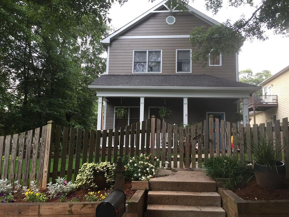 Fenced in yard with front view of home.